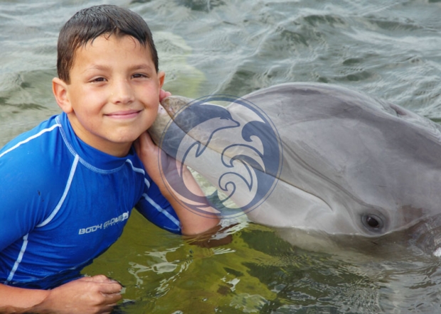 Boy getting a Dolphin Kiss
